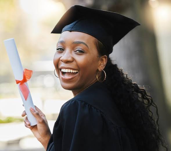 Graduate laughing joyfully with diploma