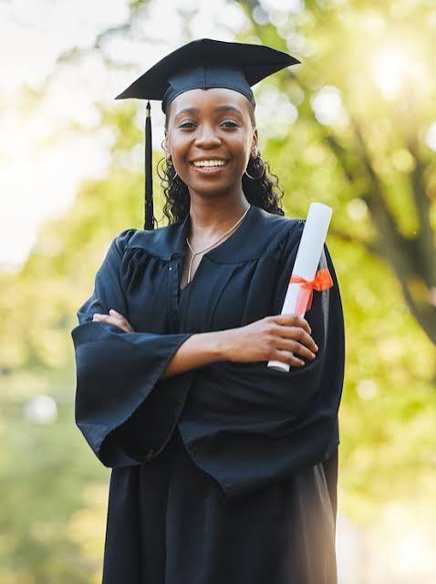 Graduate holding a diploma outdoors