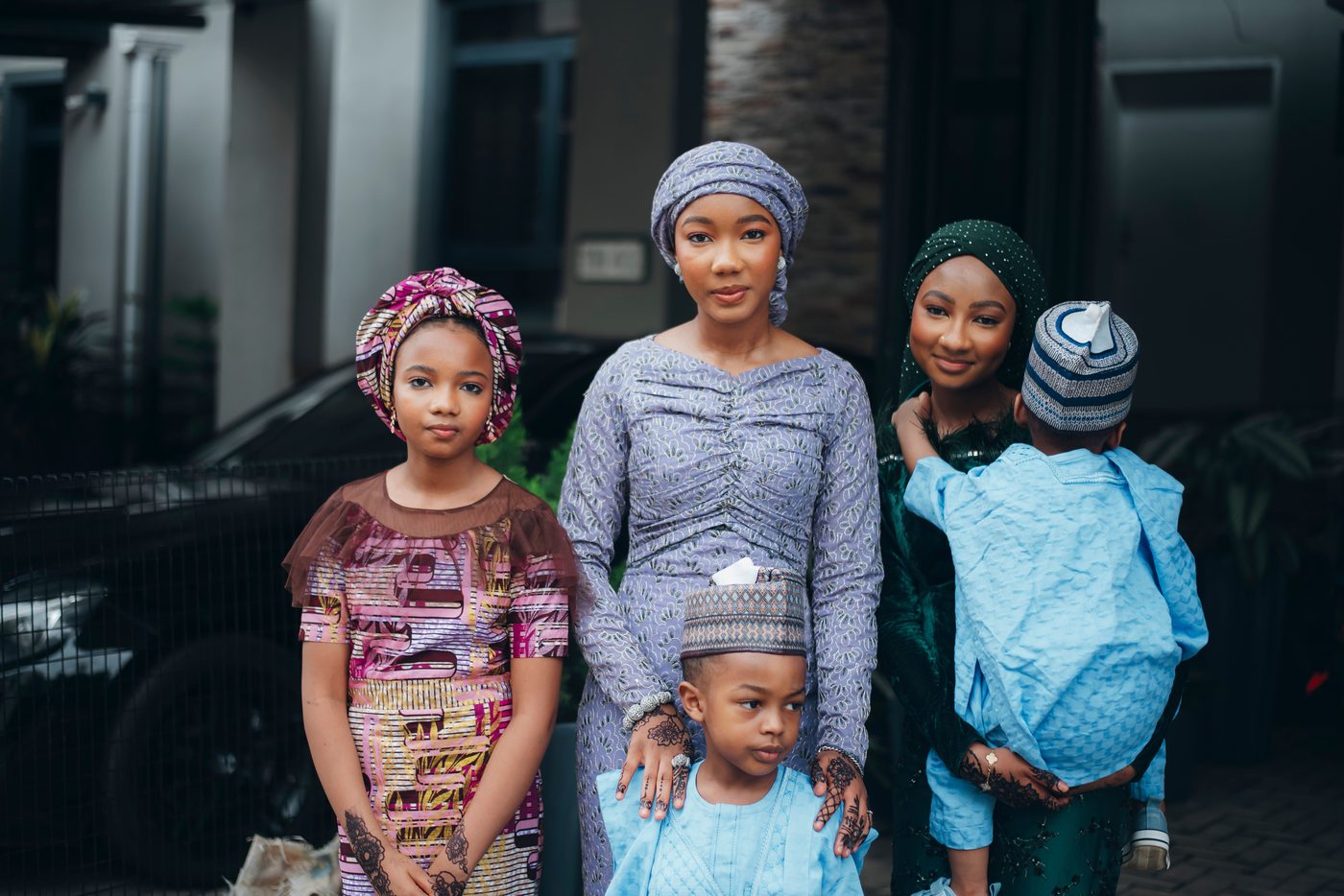 Nigerian mother in traditional attire with her three children dressed for a family celebration