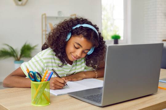 Student with headphones studying, ages 9 to 12